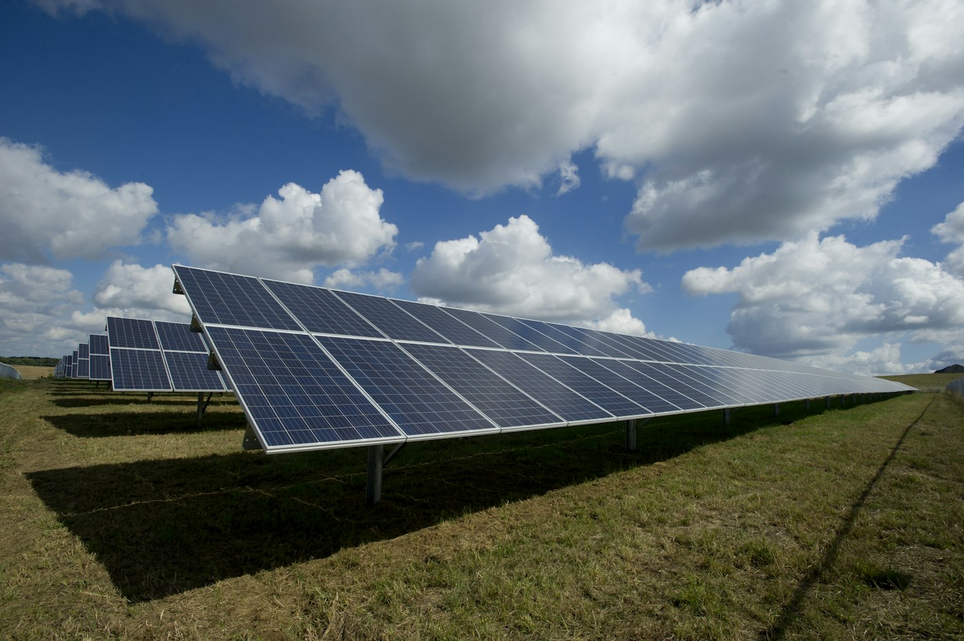 Solar panels on a family home under a blue sky
