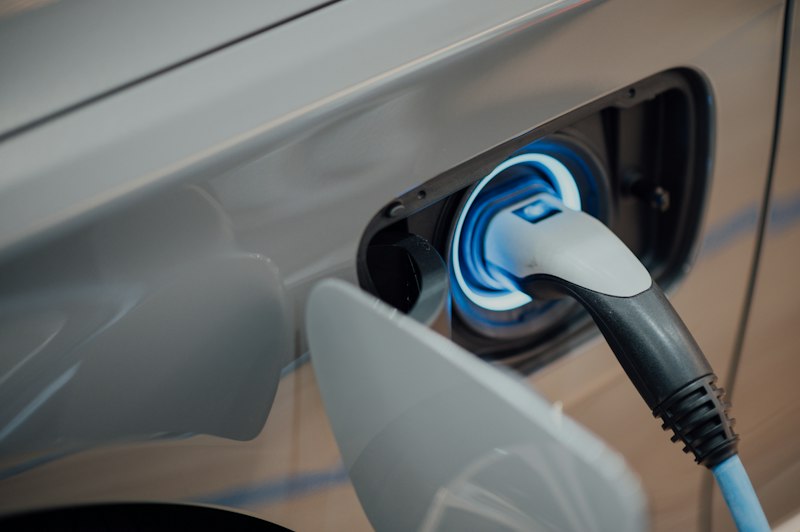 Electric car charging at a wall box with solar power