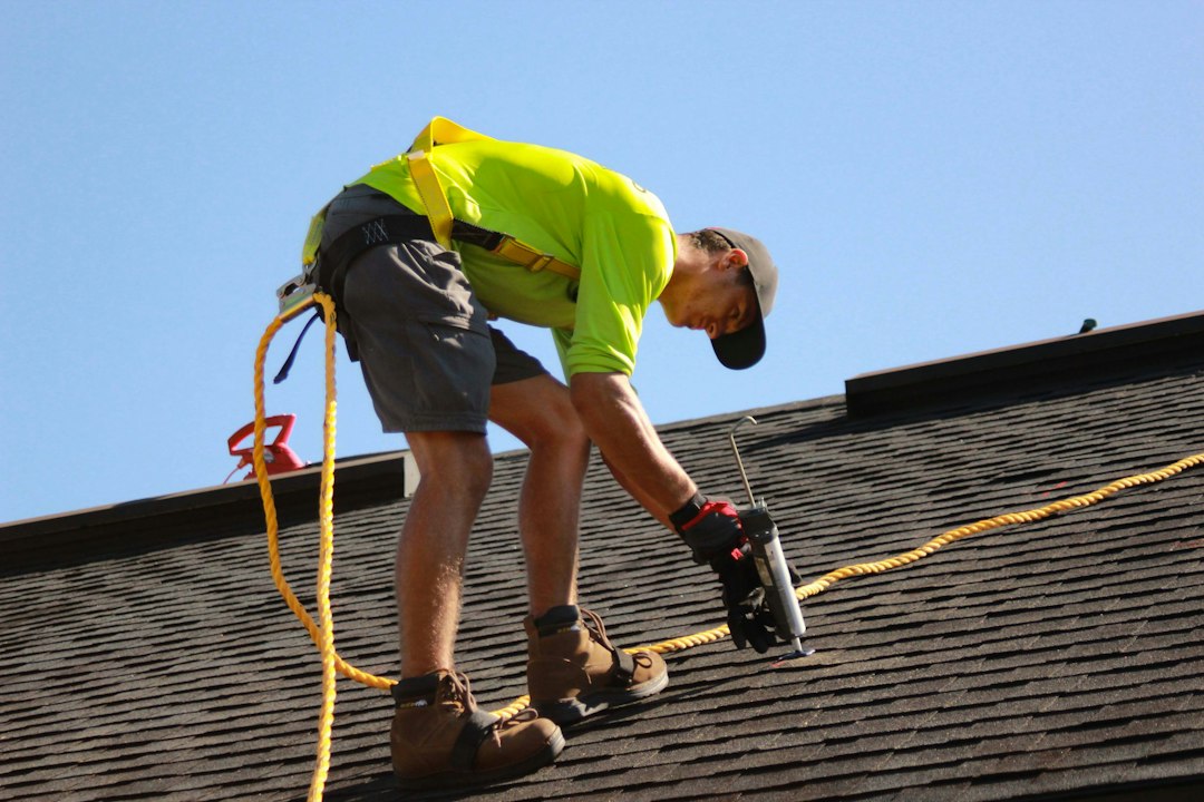 Installer fitting solar panels on a roof